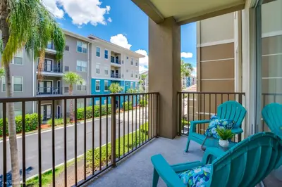 a balcony with two chairs and a balcony with condos at Gorgeous Vista Cay Condo, next to Resort Clubhouse in Orlando