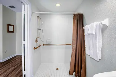 a bathroom with a shower with a shower curtain at Spacious Townhome wPatio Garage Sleeps10 in Orlando