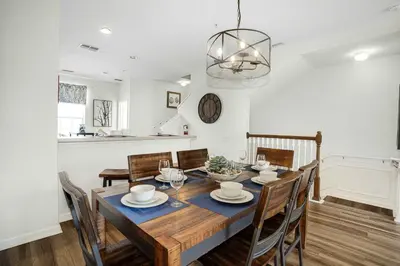 a dining room with a wooden table and chairs at Spacious Townhome wPatio Garage Sleeps10 in Orlando