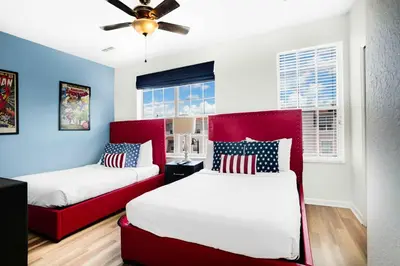 two beds in a bedroom with red and blue walls at Spacious Townhome wPatio Garage Sleeps10 in Orlando