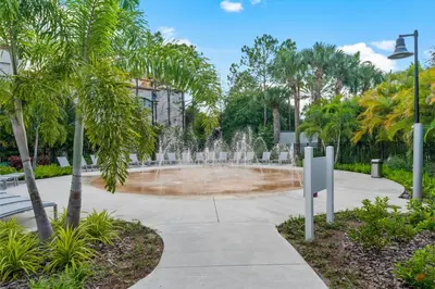 a fountain in a park with palm trees at 3-Story Townhome at Vista Cay Resort in Orlando