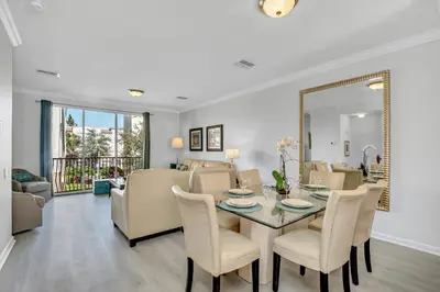 a dining room and living room with a table and chairs at NEWLY RENOVATED Townhome, Near Universal & I-Drive in Orlando