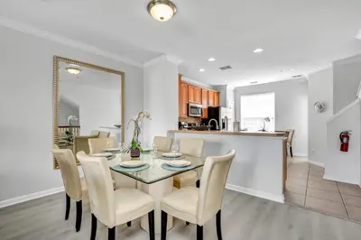 a dining room and kitchen with a table and chairs at NEWLY RENOVATED Townhome, Near Universal & I-Drive in Orlando