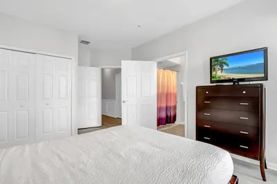 a bedroom with a bed and a flat screen tv at NEWLY RENOVATED Townhome, Near Universal & I-Drive in Orlando