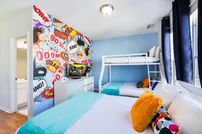 a bedroom with two bunk beds and a mural at Beautiful Newly Updated Townhome Sleeps 10 in Orlando