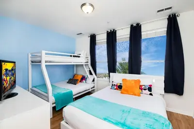 a bedroom with two bunk beds and a window at Beautiful Newly Updated Townhome Sleeps 10 in Orlando
