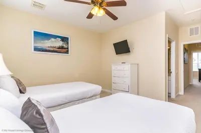 a bedroom with two beds and a ceiling fan at Spacious Vista Cay Townhome Newly Furnished in Orlando