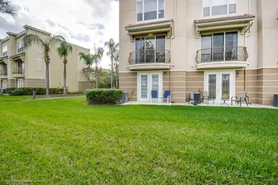 a building with a lawn in front of it at Spacious Vista Cay Townhome Newly Furnished in Orlando
