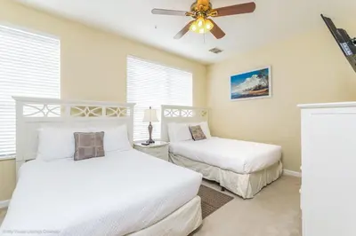 a bedroom with two beds and a ceiling fan at Spacious Vista Cay Townhome Newly Furnished in Orlando