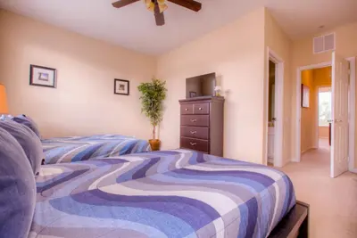 a bedroom with a bed and a dresser at Gorgeous Townhome w FREE Resort Access in Orlando