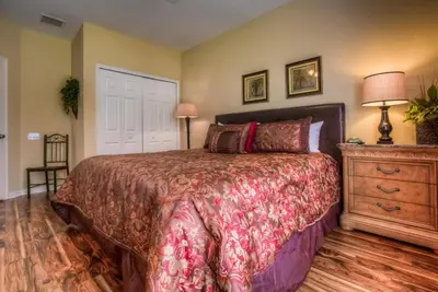 a bedroom with a bed and a dresser at Resort Townhome: Perfect Orlando Vacation Spot in Orlando