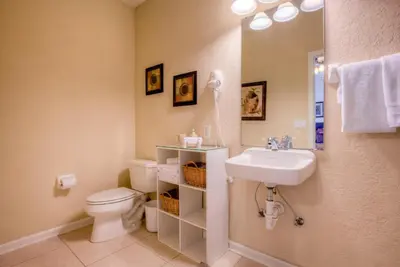 a bathroom with a toilet and a sink at Resort Townhome: Perfect Orlando Vacation Spot in Orlando