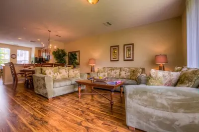 a living room with two couches and a table at Resort Townhome: Perfect Orlando Vacation Spot in Orlando