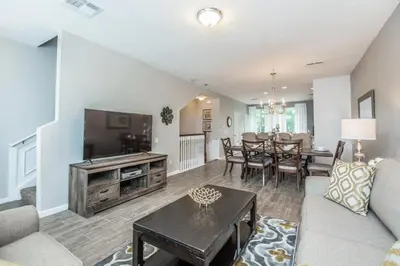 a living room with a couch and a tv and a table at At Tideview in Orlando