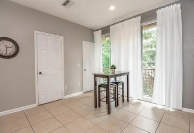 a dining room with a table and a clock at At Tideview in Orlando