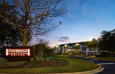 a hotel sign in front of a building at Staybridge Suites Orlando South by IHG in Orlando
