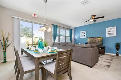 a living room with a table and a couch at Four Bedrooms TownHome 5161 in Kissimmee
