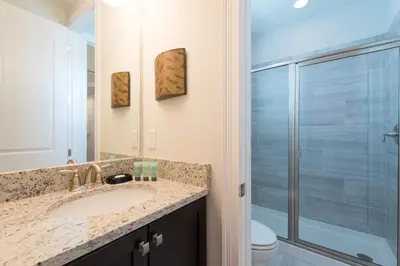 a bathroom with a sink and a shower at Splendid Home With Private Pool, Loft Area, Waterpark & Resort Access Near Disney At Encore Resort - 7619Br in Kissimmee