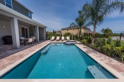 a swimming pool in the backyard of a house at Splendid Home With Private Pool, Loft Area, Waterpark & Resort Access Near Disney At Encore Resort - 7619Br in Kissimmee