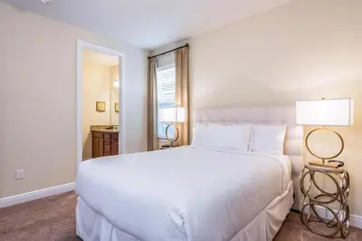 a bedroom with a large white bed with two lamps at Welcoming Home With Private Pool Near Disney With Waterpark & Resort Access At Encore Resort - 761La in Kissimmee