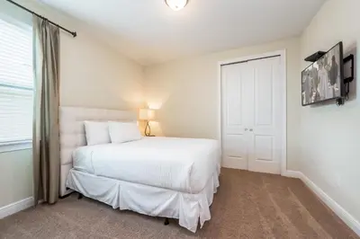 a bedroom with a white bed and a window at Elegant Home Near Disney With Private Pool And Waterpark & Resort Access At Encore Resorts Reunion - 621La in Kissimmee