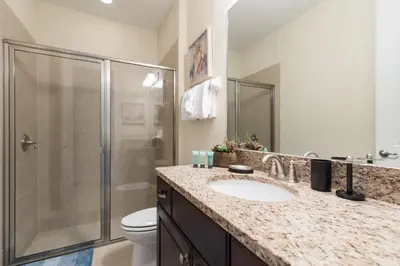 a bathroom with a shower and a sink and a toilet at Vibrant Home Near Disney With Private Pool, Themed Rooms And Waterpark & Resort Access At Encore Resorts Reunion - 401No in Kissimmee