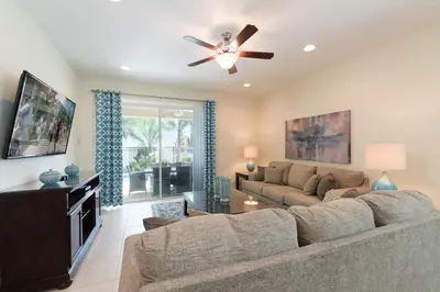 a living room with a couch and a ceiling fan at Vibrant Home Near Disney With Private Pool, Themed Rooms And Waterpark & Resort Access At Encore Resorts Reunion - 401No in Kissimmee