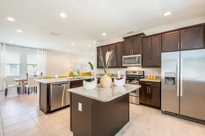 a kitchen with stainless steel appliances and a counter top at Luxurious Home Near Disney With Game Room And Waterpark & Resort Access At Encore Resorts Reunion - 371Fl in Kissimmee