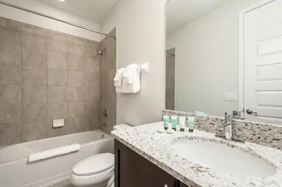 a bathroom with a sink and a toilet and a tub at Luxurious Home Near Disney With Game Room And Waterpark & Resort Access At Encore Resorts Reunion - 371Fl in Kissimmee