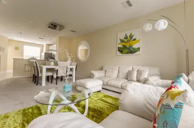 a living room with a white couch and a table at Vista Cay Inn in Orlando