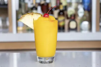 a glass of orange juice with a piece of bread at Hyatt House across from Universal Orlando Resort in Orlando