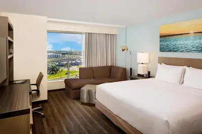 a hotel room with a bed and a couch and a window at Hyatt House across from Universal Orlando Resort in Orlando