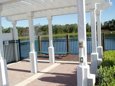 a white gazebo with a view of the water at SPECTACULAR Home And Resort! Near Dis, Splash Park, Lake With Boats, Pool, This Home And Resort Has It ALL! Low Rates Too! in Kissimmee