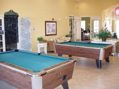 a living room with two pool tables in it at SPECTACULAR Home And Resort! Near Dis, Splash Park, Lake With Boats, Pool, This Home And Resort Has It ALL! Low Rates Too! in Kissimmee