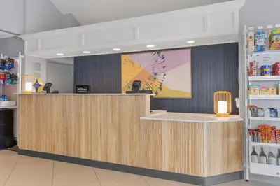 a lobby with a counter in a store at Spark by Hilton Orlando near SeaWorld in Orlando