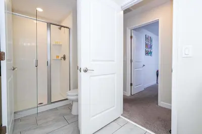 a bathroom with a toilet and a glass shower at Family Friendly Four Bedrooms w/ Pool 4896 in Kissimmee