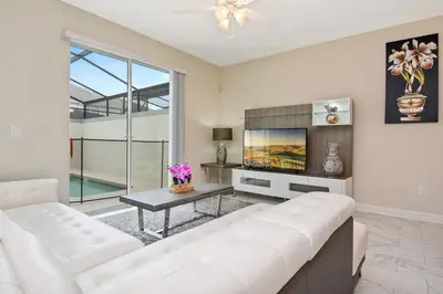 a living room with a white couch and a table at Four Bedrooms close to Disney w Pool 4898 in Kissimmee