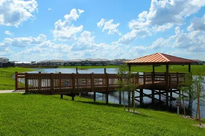 a wooden bridge over a river with a gazebo at Four Bedrooms close to Disney w Pool 4898 in Kissimmee