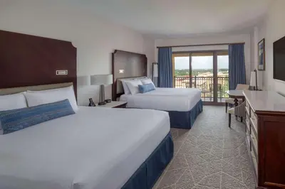 a hotel room with two beds and a balcony at Wyndham Grand Orlando Resort Bonnet Creek in Orlando
