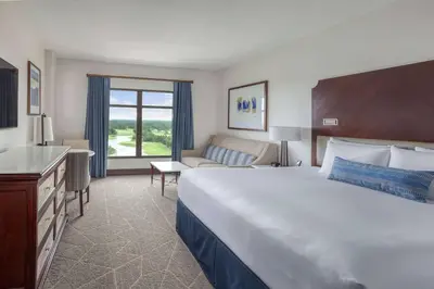 a hotel room with a large bed and a couch at Wyndham Grand Orlando Resort Bonnet Creek in Orlando