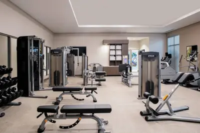 a gym with several treadmills and exercise machines at TownePlace Suites by Marriott Orlando Theme Parks Lake Buena Vista in Orlando