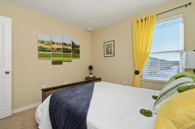 a bedroom with a bed and a window at Family Friendly 4 Bedroom Close to Disney 5148 in Kissimmee