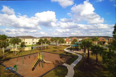 a playground with a slide in a park at Family Friendly 4 Bedroom Close to Disney 5148 in Kissimmee