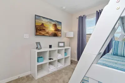 a bedroom with a bunk bed and a staircase at Four Bedroom w/ GameRoom 5152A in Kissimmee