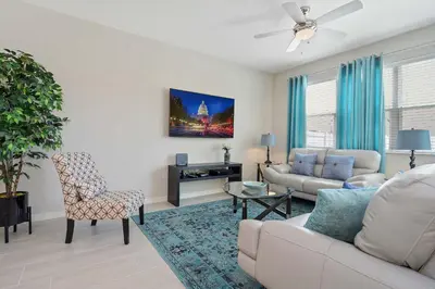 a living room with a couch and a chair at Four Bedroom w/ GameRoom 5152A in Kissimmee