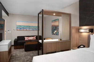 a hotel room with a bed and a couch at SpringHill Suites by Marriott Orlando Theme Parks Lake Buena Vista in Orlando