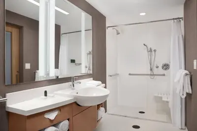 a bathroom with a sink and a shower at SpringHill Suites by Marriott Orlando Theme Parks Lake Buena Vista in Orlando