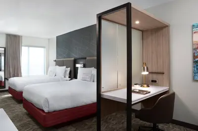 a hotel room with two beds and a desk at SpringHill Suites by Marriott Orlando Theme Parks Lake Buena Vista in Orlando