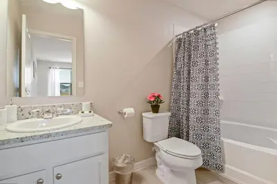 a bathroom with a sink and a toilet and a mirror at Family Friendly Four Bedrooms 5145 in Kissimmee