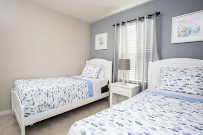 a bedroom with two beds and a window at Family Friendly Four Bedrooms 5147A in Kissimmee